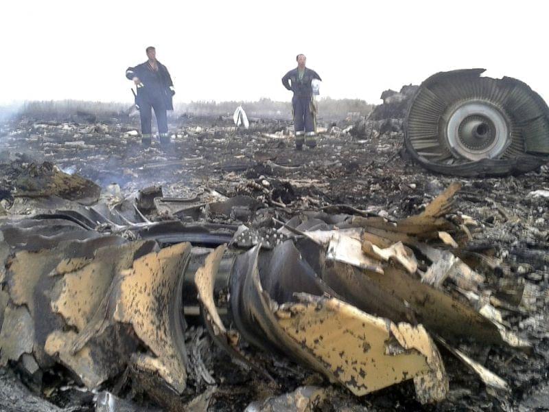 Ukrainian workers are seen at site of crash site