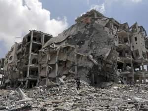 Palestinian searches for salvageable items in rubble