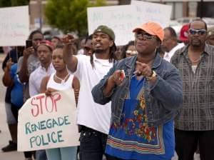 Protesters confront police Sunday in Ferguson, MO.