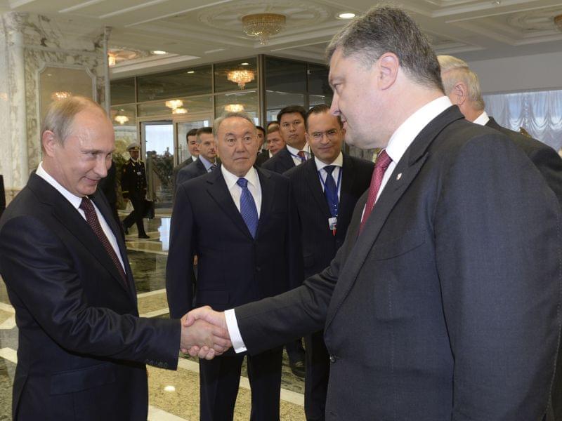Vladimir Putinshakes hands with Ukrainian President Petro Poroshenko,after posing for a photo in Minsk, Belarus, August 26.
