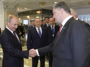 Vladimir Putinshakes hands with Ukrainian President Petro Poroshenko,after posing for a photo in Minsk, Belarus, August 26.
