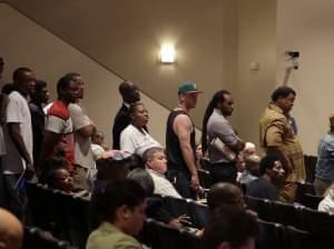 A line of people wait to speak during a meeting of the Ferguson City Council. 