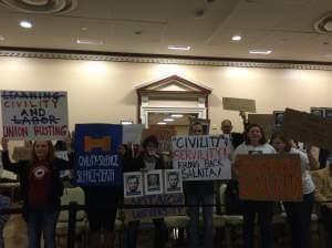 Backers of Steven Salaita carry signs, showing their support during the U of I Trustees meeting.