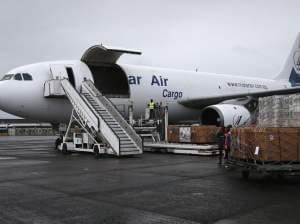 Workers unload medical supplies from a USAID cargo plans in Liberia in August. 