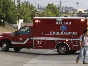 An ambulance pulls out for a run from a Dallas fire station. An EMT crew there is on a 21 day quarantine.