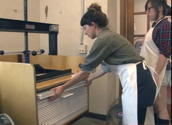 two people making paper