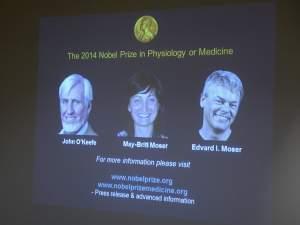 A screen presents the winners of the Nobel Prize in Medicine