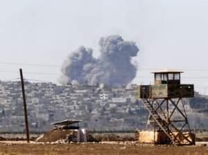 Smoke rises from the Syrian town of Kobani, near the Syrian border.