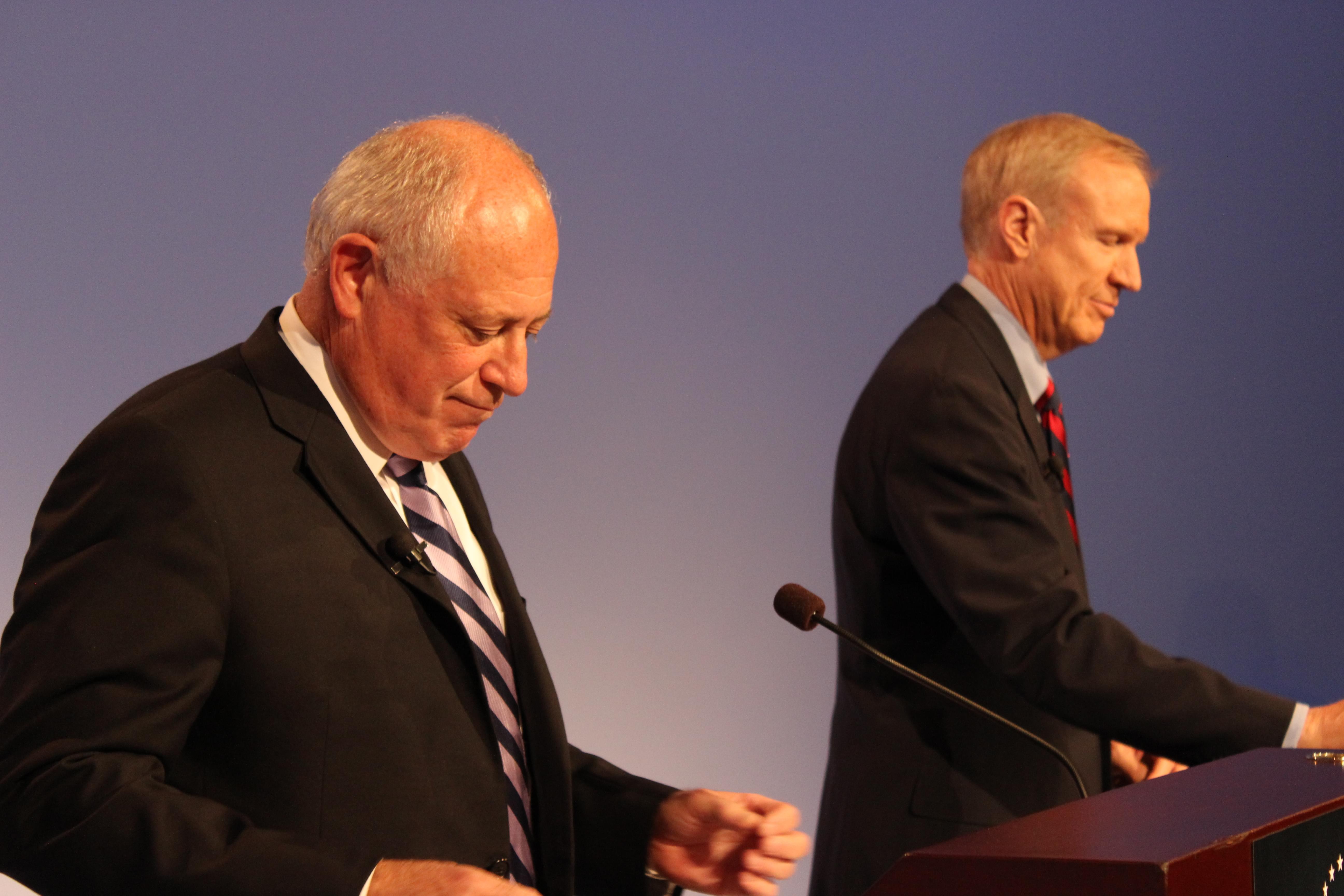 Governor Pat Quinn and Republican challenger Bruce Rauner gather themselves before their debate in Peoria Thursday night.