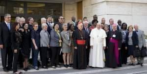 Pope Frances poses for a photo with lay members at the start of a two week synod on family issues.  