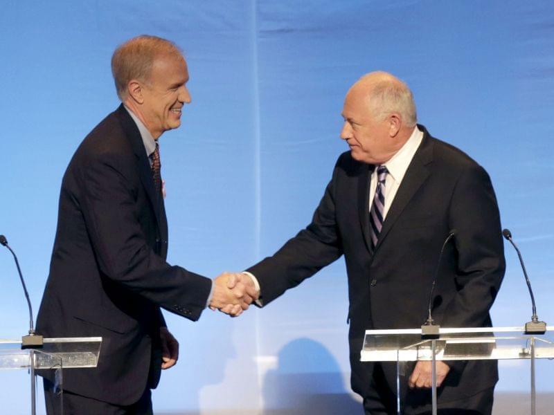 Pat Quinn and Bruce Rauner greet before a debate in Chicago Tuesday.
