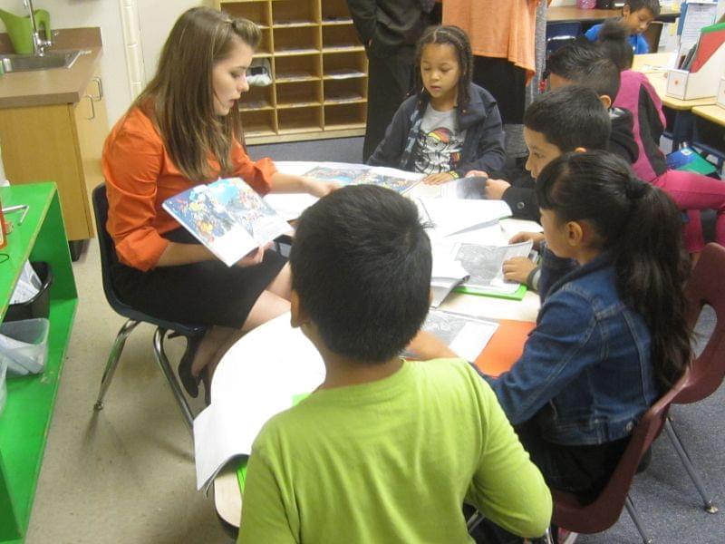 Teacher Kelsey Schoenecke goes through a book with 2nd graders in a dual language immersion class at Urbana's Prairie School.