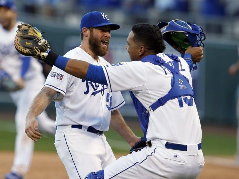 Relief pitcher Greg Holland and catcher Salvador Perez celebrate after the Kansas City Royals defeat Baltimore 2-1 in Game 4 of the AL championship series.