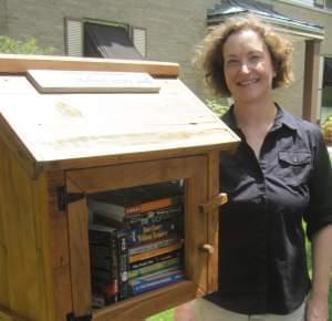 Cara Finnegan stands by her Little Free Library in Champaign.