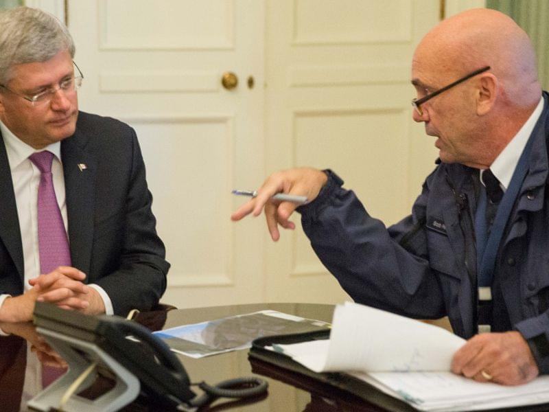 Canadian prime Minister Stephen Harper being briefed by RCMP head Bob Paulson on the Parliament Hill shootings.