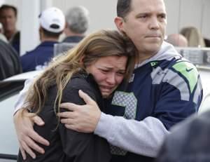People react as they wait at a church where students were taken to meet with parents after a shooting in Marysville, Washington.