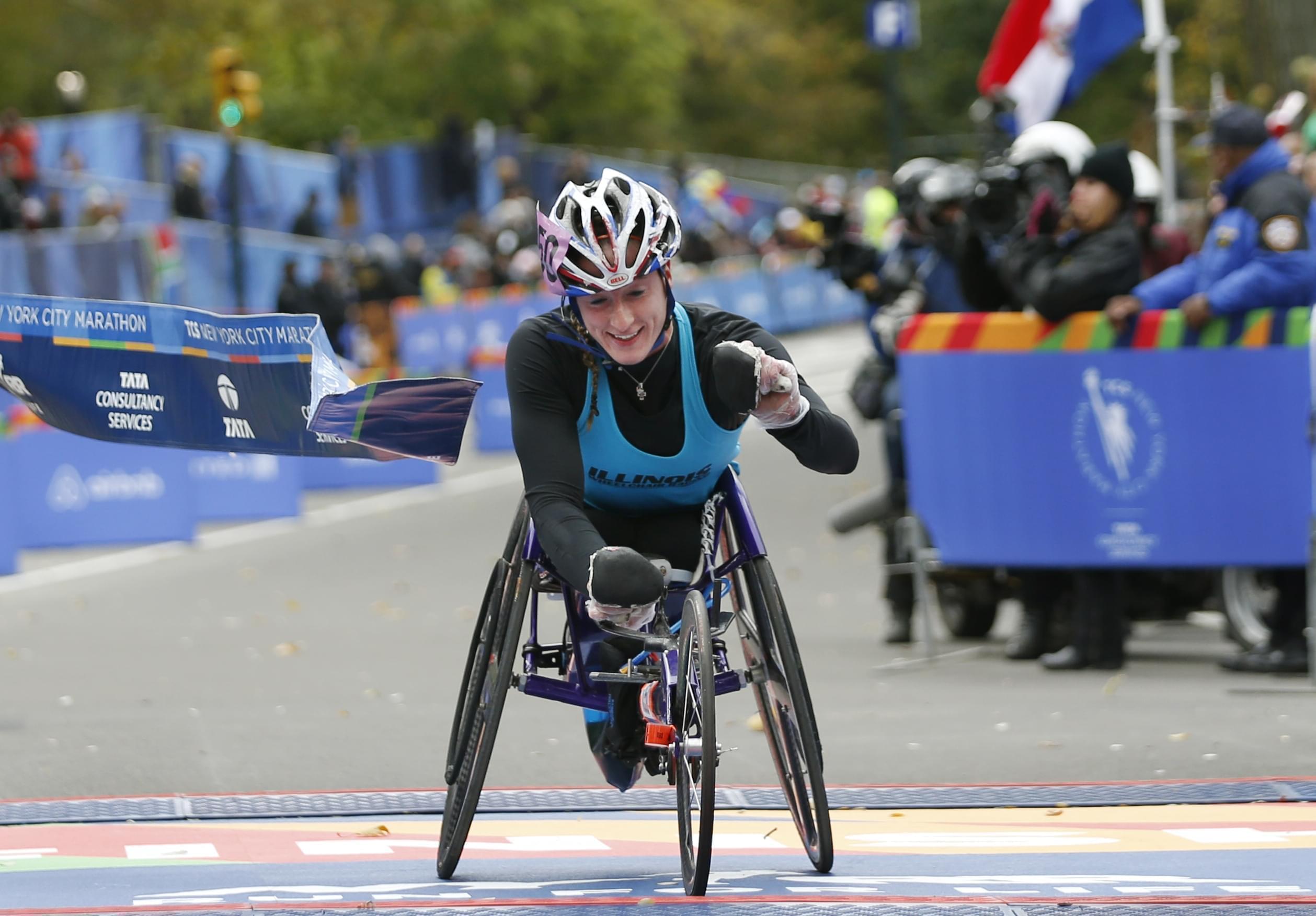 Tatyana McFadden reacts as she breaks the tape after finishing first in the women's wheelchair racing division in New York Sunday.