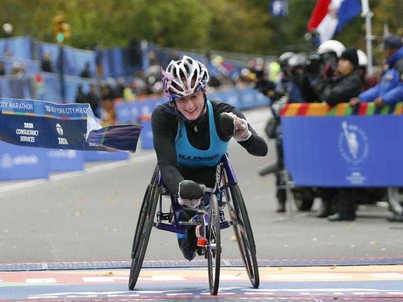 Tatyana McFadden reacts as she breaks the tape after finishing first in the women's wheelchair racing division in New York Sunday.