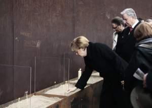 German Chancellor Angela Merkel and the Mayor of Berlin Klaus Wowereit place candles to commemorate victims at the Berlin Wall Memorial Site.