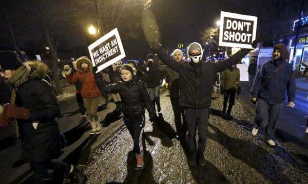 Protesters march during a rally near Chicago Police headquarters Monday night.