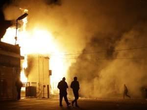 A storage facility in Ferguson, MO, burns after a grand jury ruled against filing charges against Ofc. Darren Wilson.