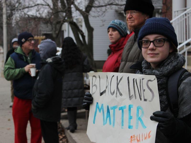 Protesters line Springfield Avenue in Champaign Friday. 