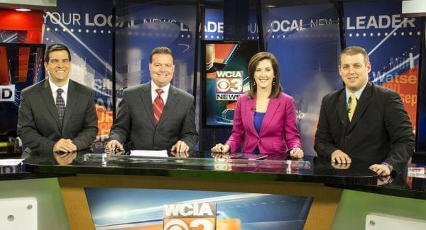 Dave Benton - second from left -and WCIA staff in an evening broadcast.