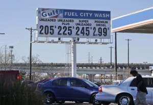 Vehicles line up to take advantage of low gas prices at the Fuel City gas station in Dallas.