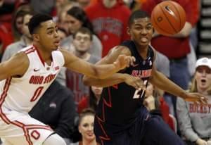 D'Angelo Russell of Ohio State and Malcolm Hill of Illinois chase a loose ball Saturday. 