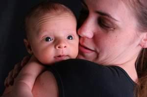 a mother holding her young baby