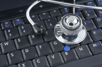 a stethoscope sitting on a computer keyboard 