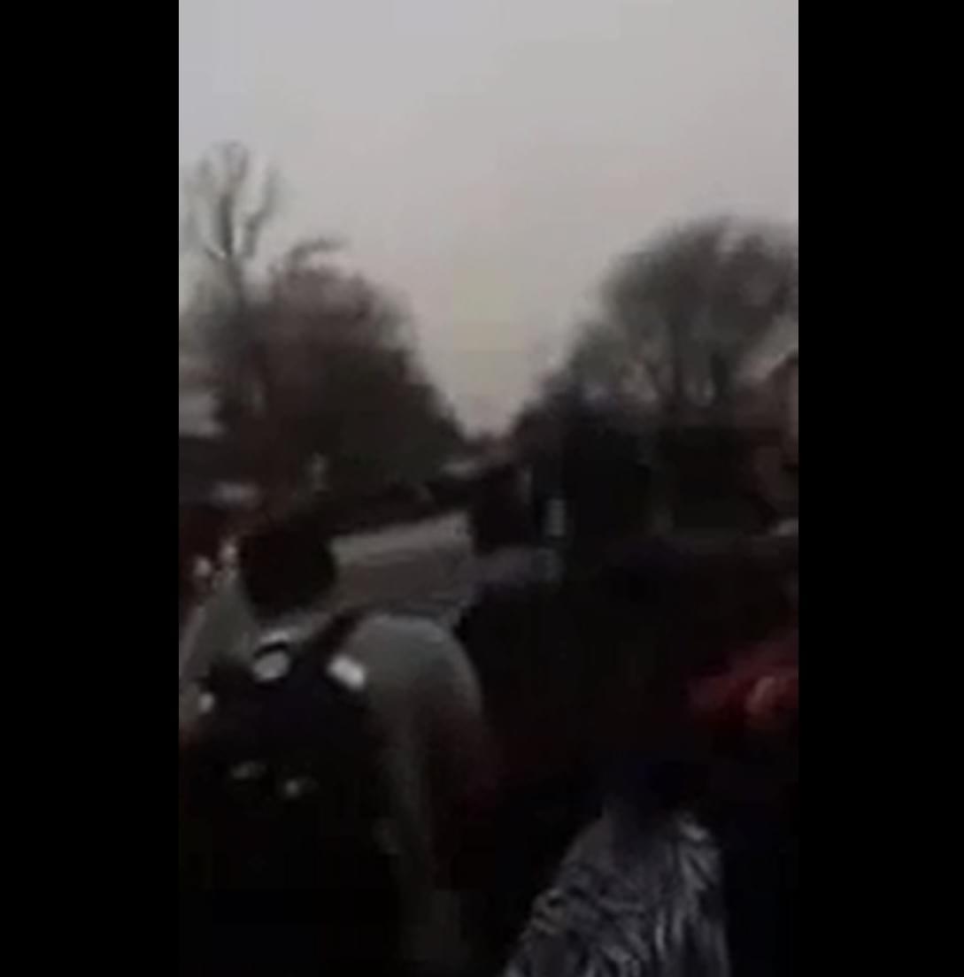 Screenshot of video showing a car driving through a student rally outside Centennial High School.