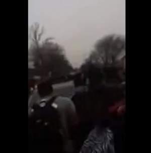 Screenshot of video showing a car driving through a student rally outside Centennial High School.