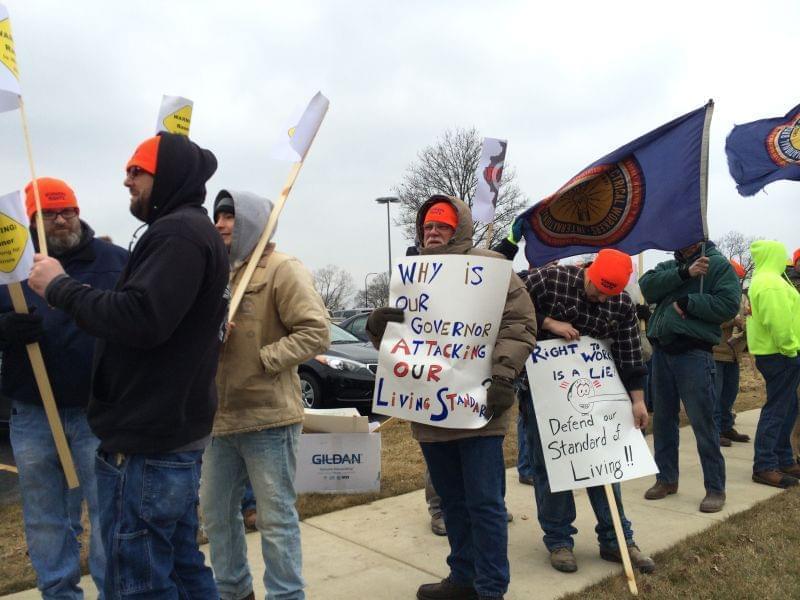 Local union members turn out for a rally outside Gov. Rauner's speech in Champaign on Thursday.