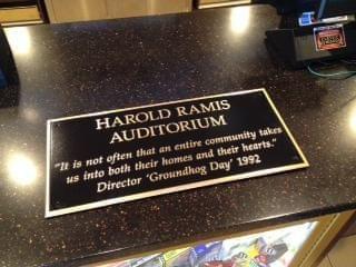 A plaque that reads "Woodstock Theater Dedicates Auditorium To Harold Ramis"