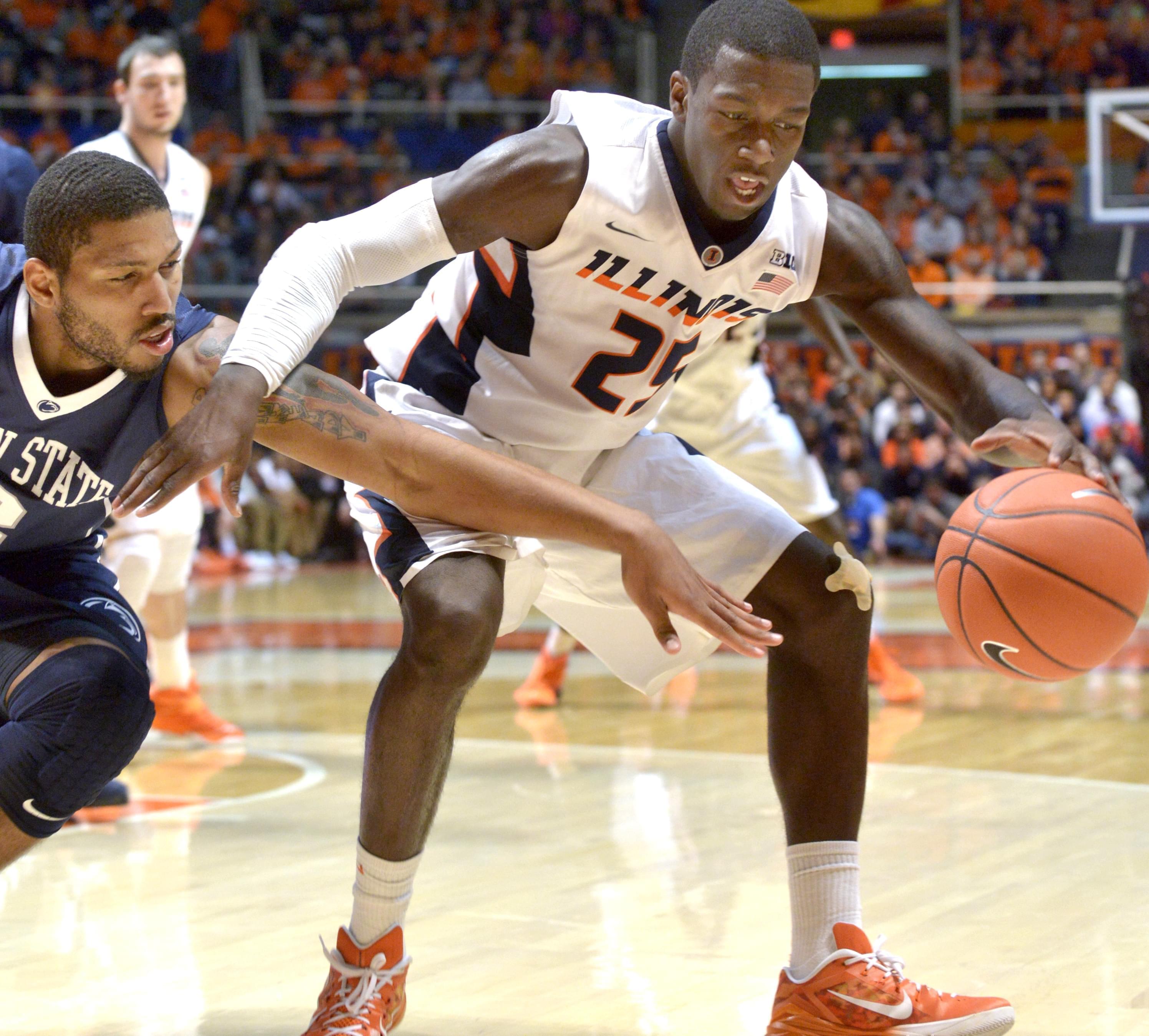 Illinois' Kendrick Nunn controls the ball in front of Penn State Guard D. J. Newbill.