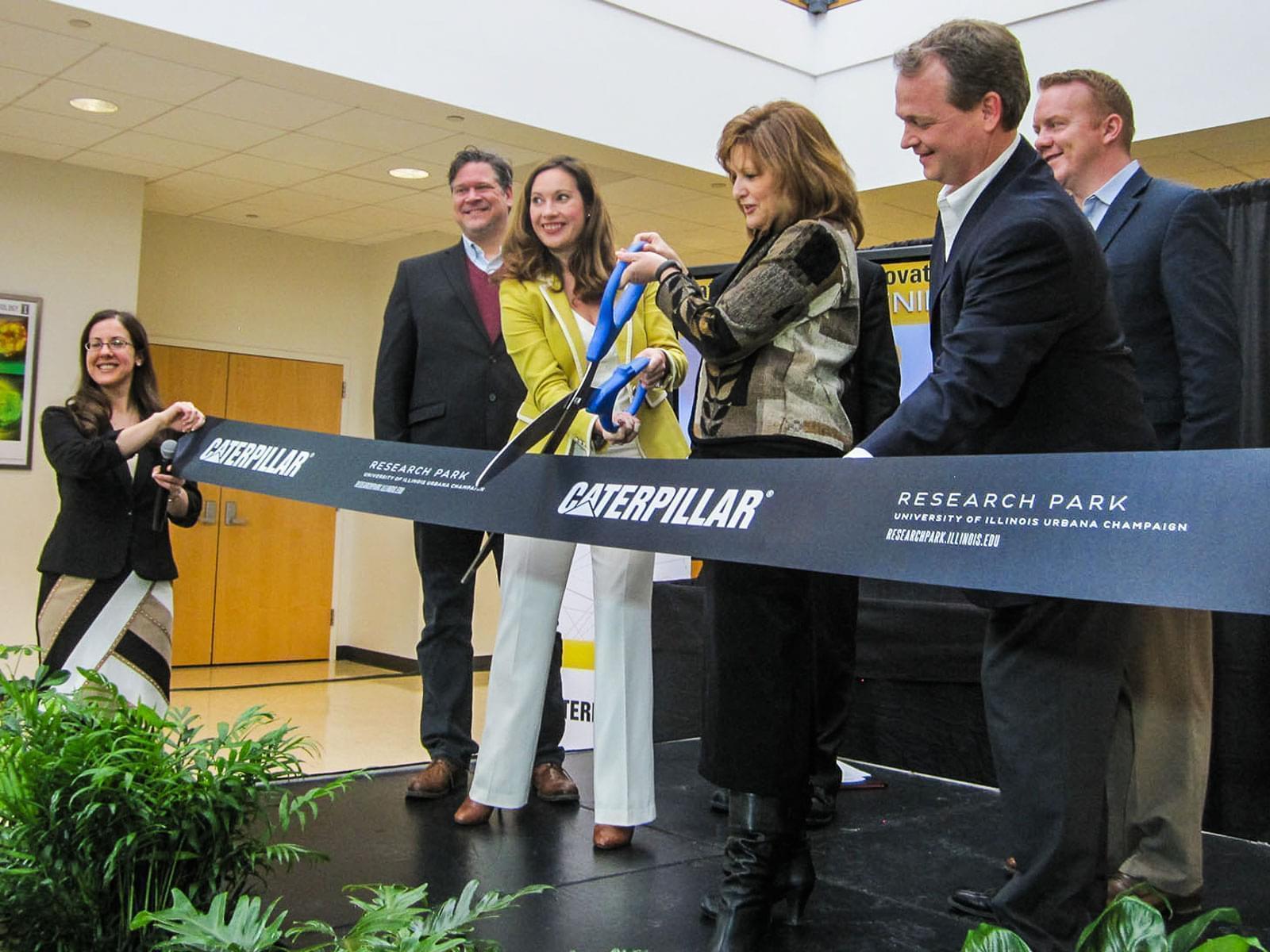 Caterpillar, University of Illinois and Champaign officials cut a ceremonial ribbon to open the Caterpillar Data Innovation Lab.