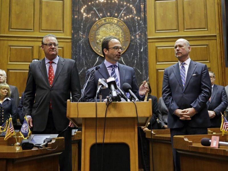 Scott McCorkle, CEO Salesforce.com, joins Indiana Senate President Pro Tem David Long, left, and House Speaker Brian C. Bosma as they announce changes to the state's new religious objections law. 