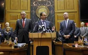 Scott McCorkle, CEO Salesforce.com, joins Indiana Senate President Pro Tem David Long, left, and House Speaker Brian C. Bosma as they announce changes to the state's new religious objections law. 