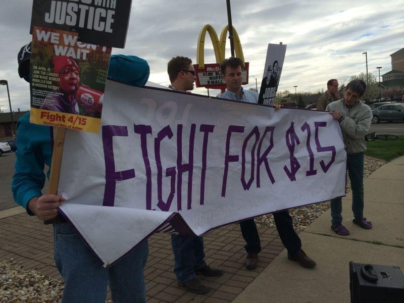 Activists rally for a $15 minimum wage outside of the McDonald&#039;s on Neil Street and Kirby Avenue in Champaign.