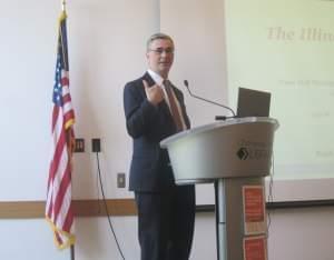 Ralph Martire of the addressed a large crowd with his fiscal plan at a town hall meeting in Champaign Monday.