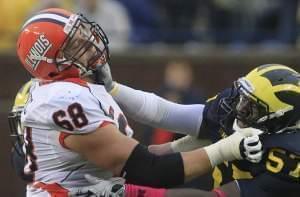 Simon Cvijanovic playing for Illinois in 2012, going up against Frank Clark of Michigan.