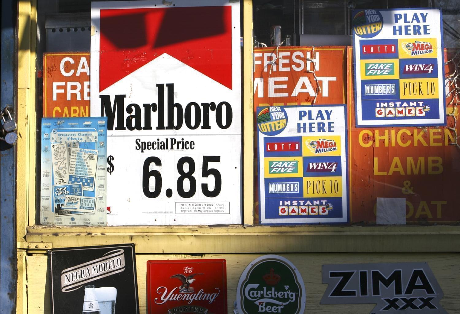 A New York convenience store displays window advertisements, including one for Marlboro cigarettes, Sunday, Dec. 11, 2005.