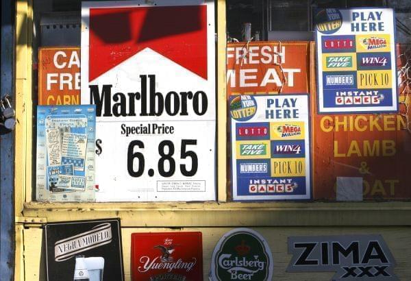 A New York convenience store displays window advertisements, including one for Marlboro cigarettes, Sunday, Dec. 11, 2005. 