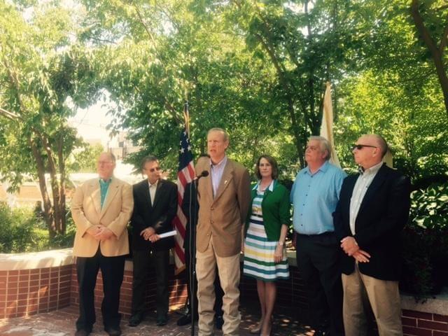 Gov. Bruce Rauner stands next to Senate Republican Leader Christine Radogno and others decrying property taxes during a press conference in the governor's mansion gardens.