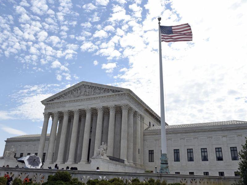 The flag flies in the wind in front of the Supreme Court in Washington, Monday, June 22.