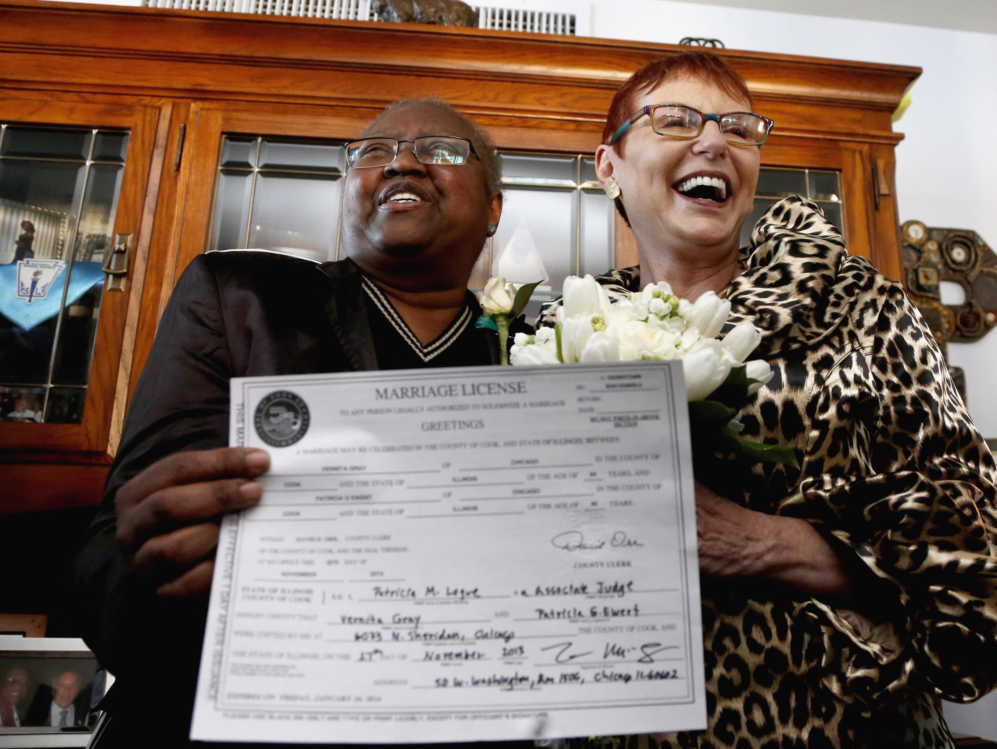 n this Nov. 27, 2013 file photo, Vernita Gray and Patricia Ewert hold their Illinois marriage license at their home in Chicago following their marriage by a Cook County judge. They were granted an exception to marry before Illinois' law formally