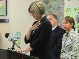 Kristina Rath, whose 11-year old son is autistic, gets emotional when addressing a group at Champaign's Developmental Services Center Monday.