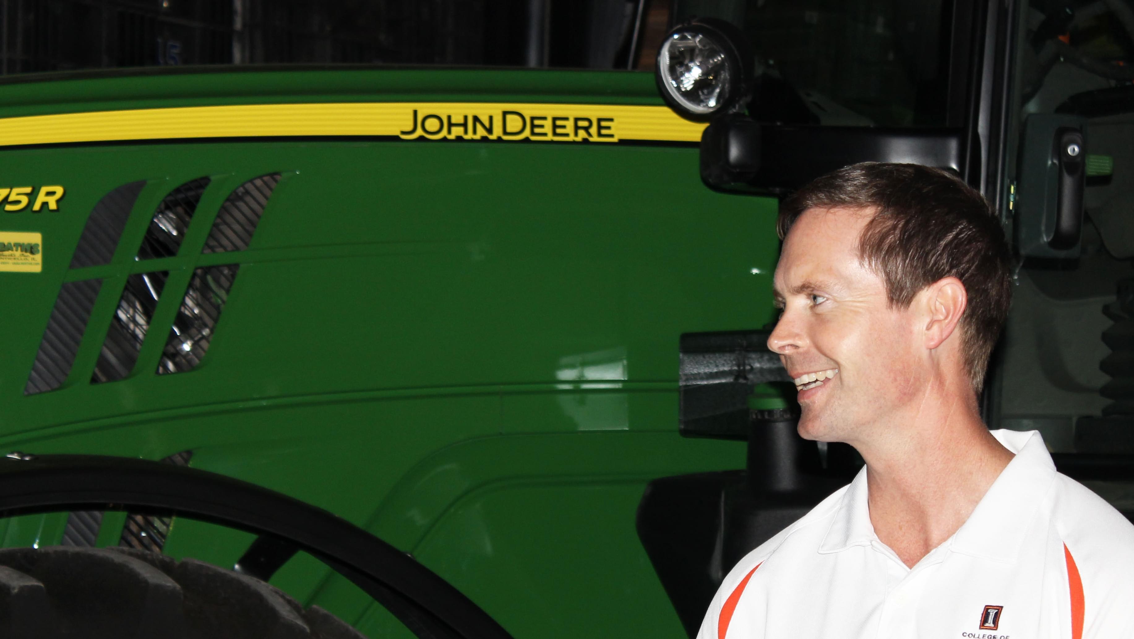 Illinois Congressman Rodney Davis stands alongside John Deere farm equipment during a tour of the AgReliant Genetics Champaign Research Station near Ivesdale. 