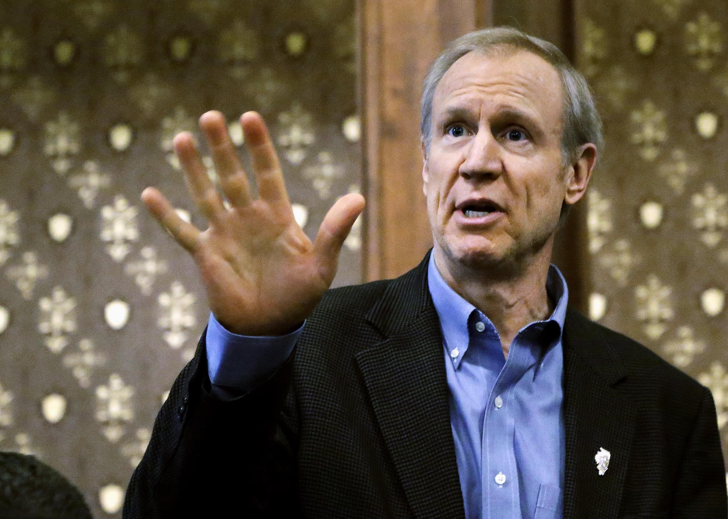 Illinois Gov. Bruce Rauner speaks to cabinet members during a meeting at the state Capitol, Feb. 25 in Springfield,